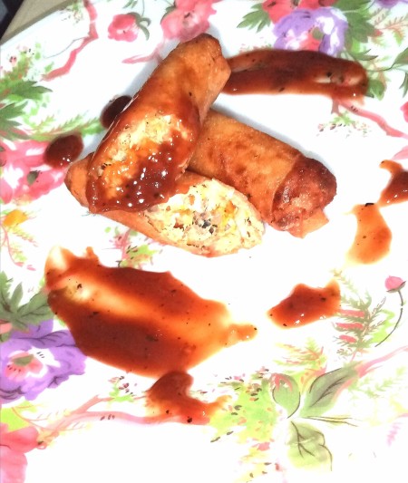 The fried roll cut in half on a plate.