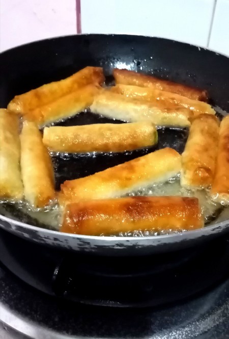 Frying the rolls.