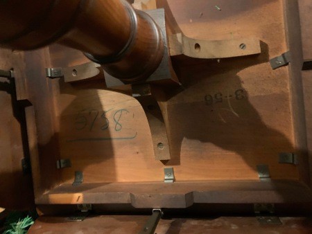 The underside of a wooden table.