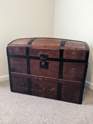 An old wooden steamer trunk.