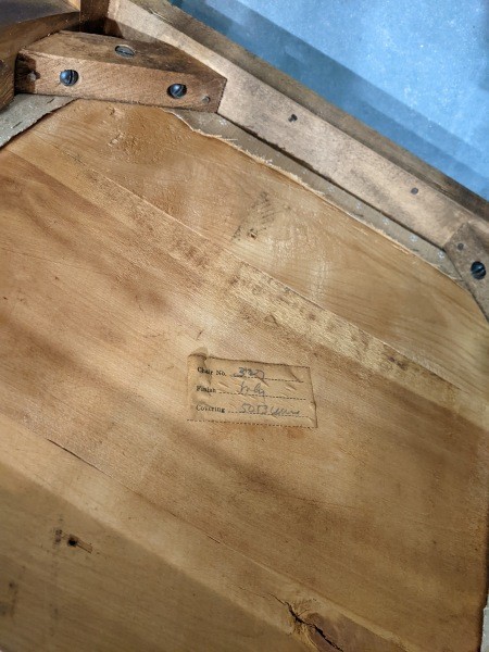 A tag on the underside of a chair.