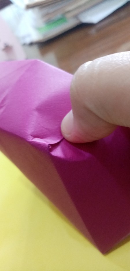 Folding the top of the box to resemble a heart.