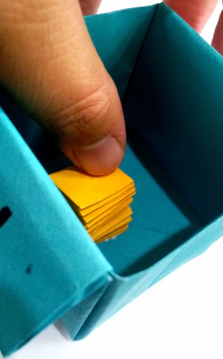 Attaching the accordion fold to the inside of the box.