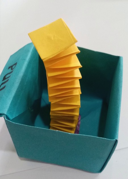 Attaching the accordion fold to the inside of the box.