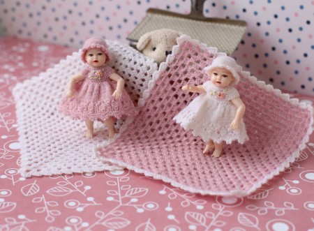 Two little dolls with handmade dresses.