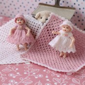 Two little dolls with handmade dresses.