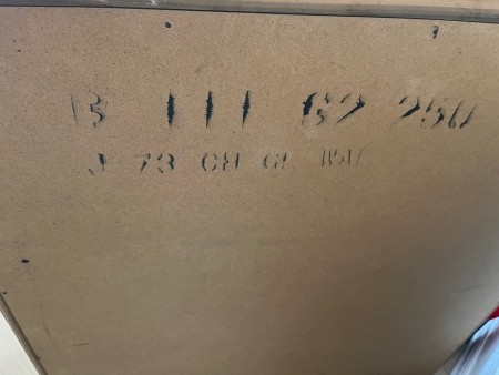 Markings on the back of a dresser.