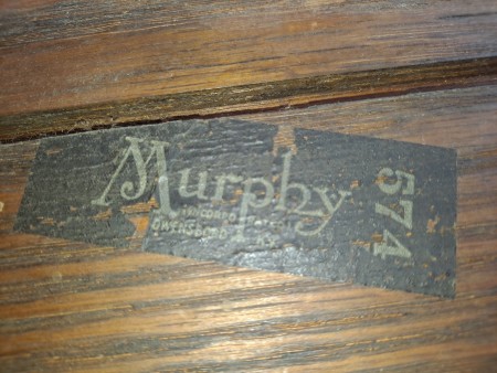 The manufacturer's logo on the bottom of a chair.