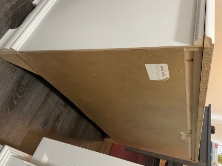 A sticker on the side of the dresser.