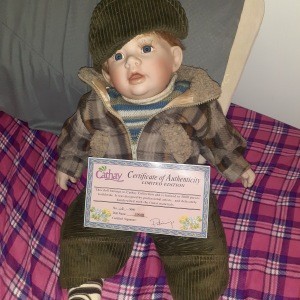 A boy doll wearing a hat.