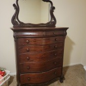 A rounded mahogany dresser.