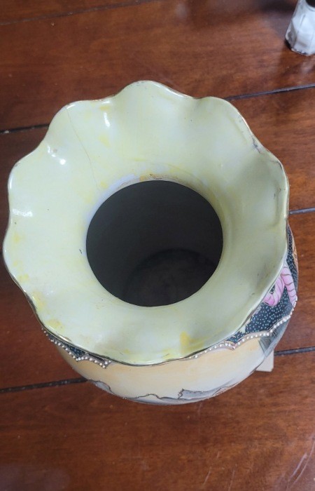 The top of a painted Japanese vase.