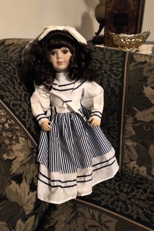 A porcelain doll in a sailor dress.