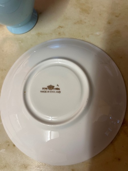 The manufacturer's marking on the bottom of the china cup.