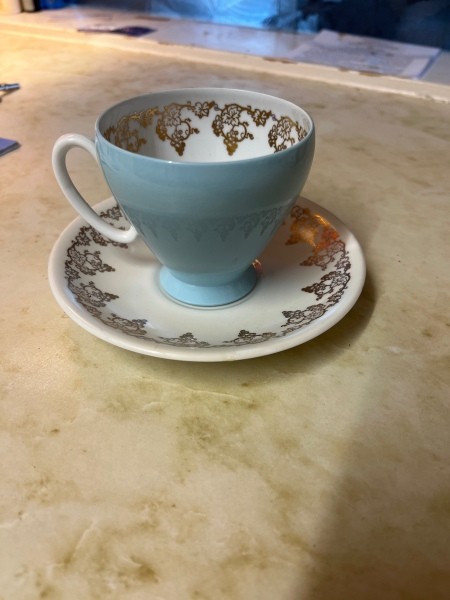 A china cup and saucer.