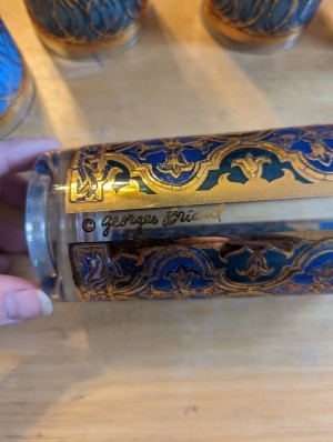 The manufacturer's marking on the side of the decorative glasses.