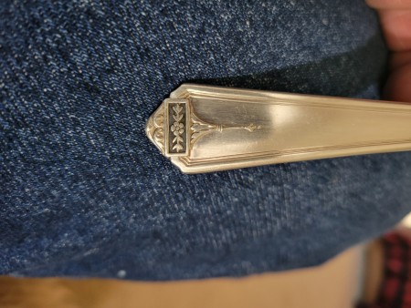 A marking on a piece of silverware.