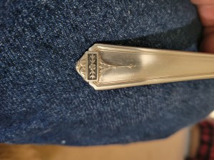 A marking on a piece of silverware.