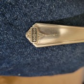 A marking on a piece of silverware.