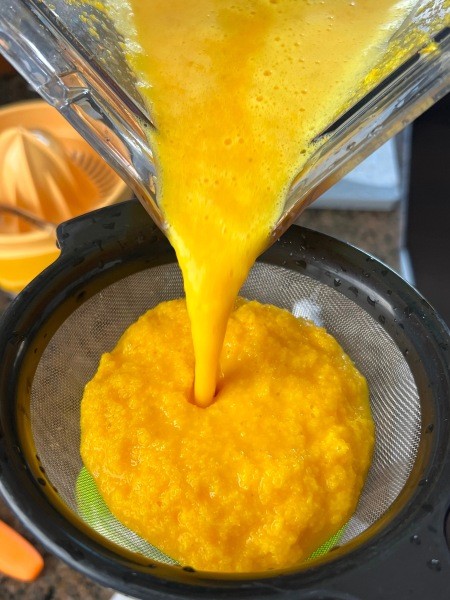 Straining the drink through a sieve.