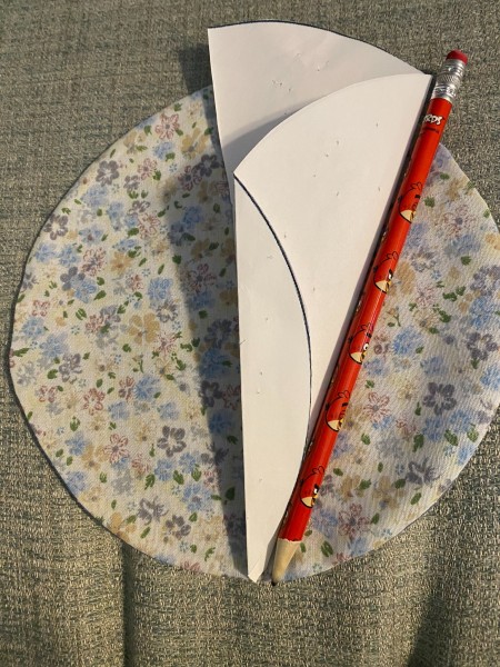 Marking a pattern onto the fabric circles.