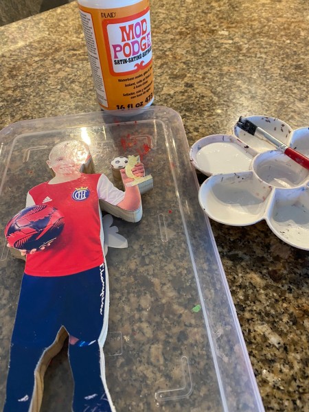 Using mod podge to seal the photograph.