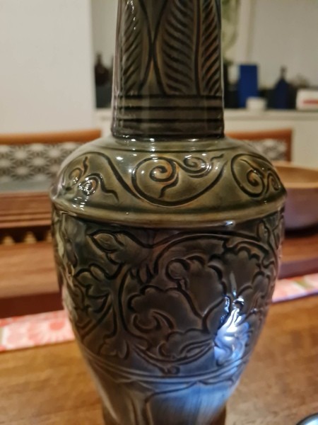 A close up of a celadon vase.