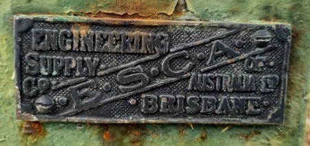A metal plaque on an old machine.