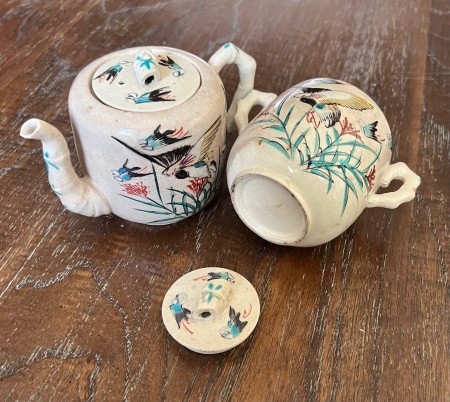 A painted ceramic tea pot set.