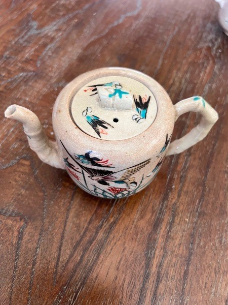 A painted ceramic tea pot set.