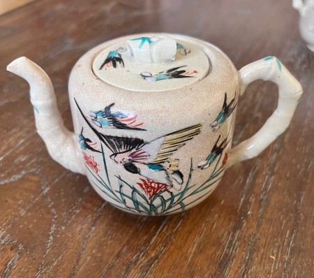 A painted ceramic tea pot set.