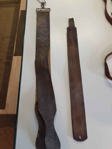 A collection of leather hand farm tools.