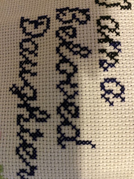 The wording cross stitched in black.