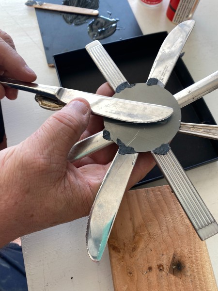 Gluing the knife pieces together.