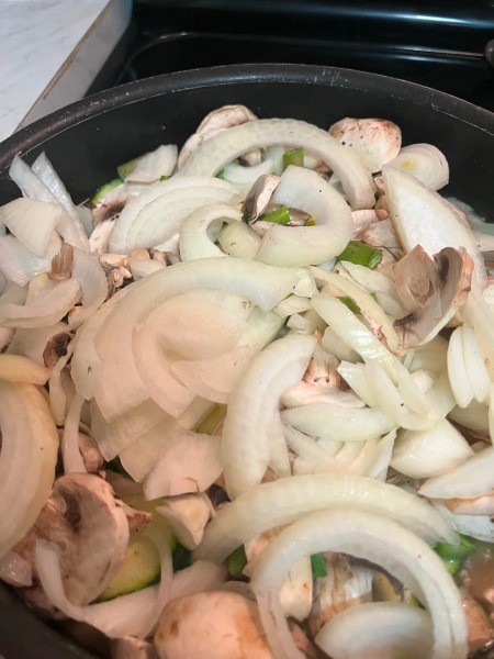Adding onions to the pan.