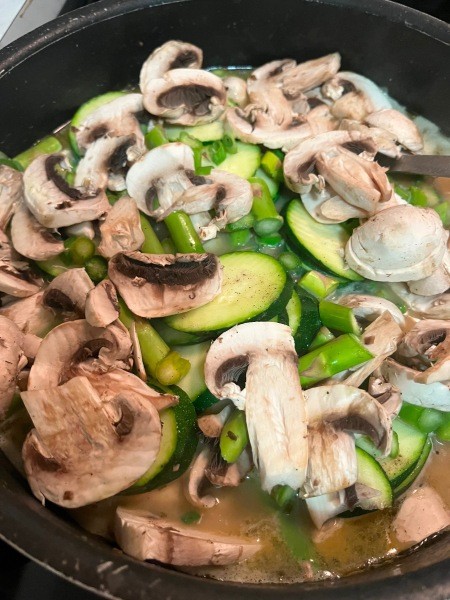 Cooking the vegetables in a pan.