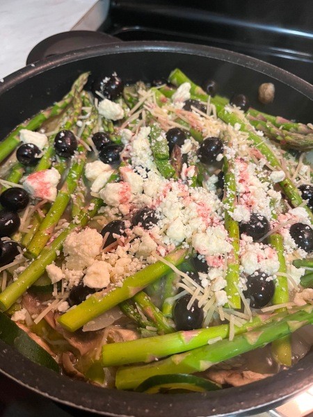 The dish topped with feta and olives.