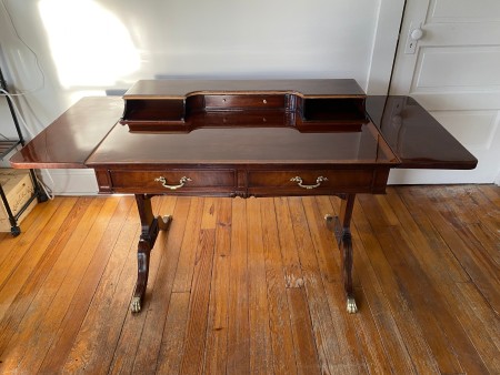 A wooden desk with side leaves.