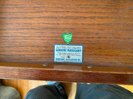 The Imperial logo on the underside of a desk.