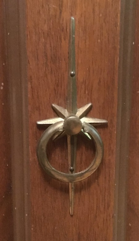 A decorative metal handle.
