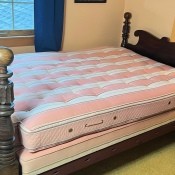 A wooden four poster bedstead.