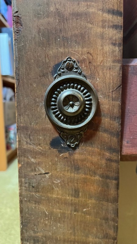 A decorative element on the leg of a bed.