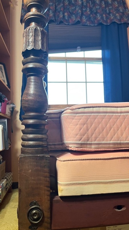 Carved details on a wooden bedstead.