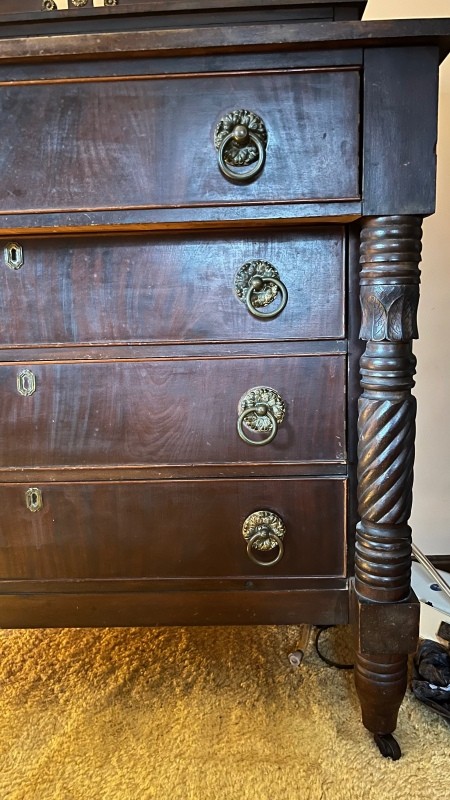 A close up of a wooden dresser.