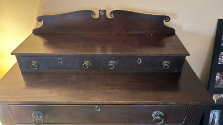 The top of a wooden dresser.