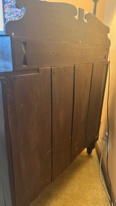 The back of a wooden bed.