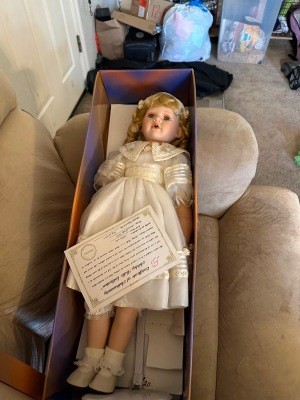 A porcelain doll in a box.