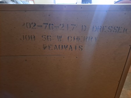 The markings on the back of the dresser.
