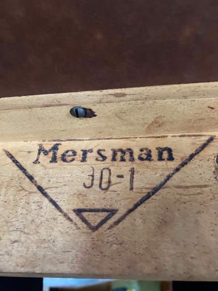The Mersman logo on the underside of the table.