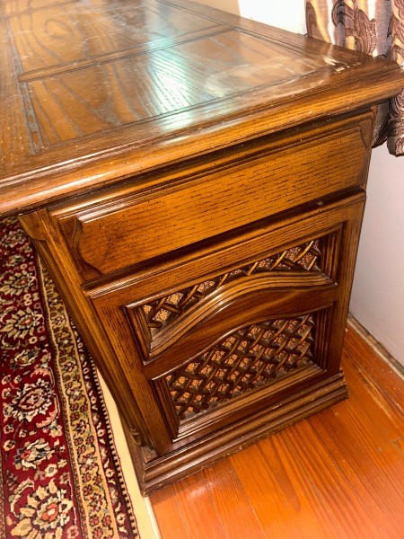 The side of a wooden stereo console.